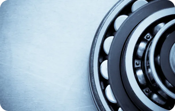 Close-up of industrial aluminum ball bearings on a metallic surface.